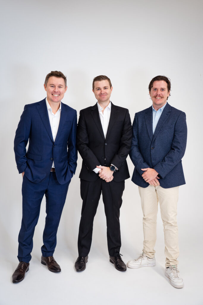 Coastal Letting Group Directors, Trent Pevy, Chris de Closey and Luke Shore standing in front of a white wall
